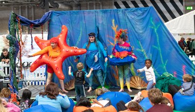 Woman dressed as a starfish, woman dress as a crab and another woman on stage at 3Generate