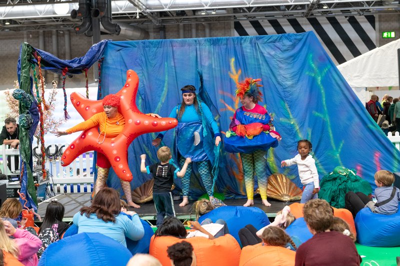 Woman dressed as a starfish, woman dress as a crab and another woman on stage at 3Generate