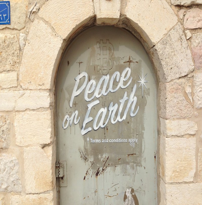 Graffiti reading peace on earth terms and conditions apply