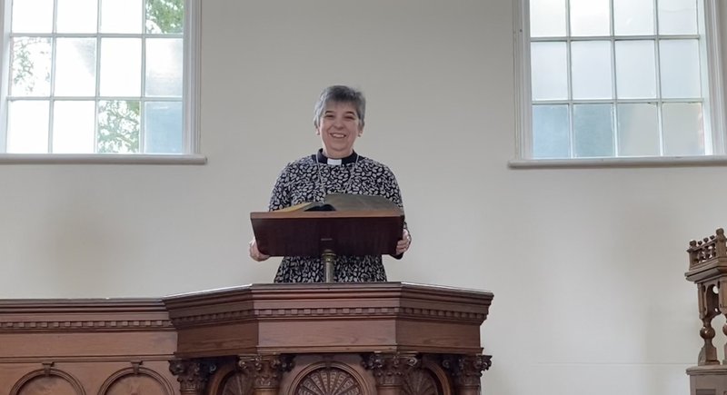 Revd Gill Newton, President of the Methodist Conference, standing in a pulpit