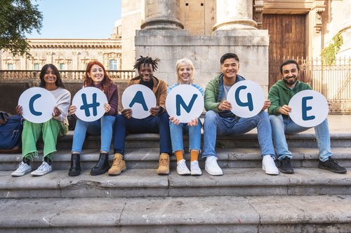 Diverse Students Holding 'CHANGE' Signs in Campaign GettyImages-1886759412
