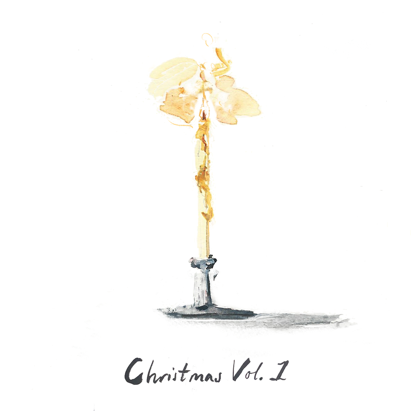 A lit candle on a stand. Text reads &#x27;Christmas Vol. 1&#x27;.