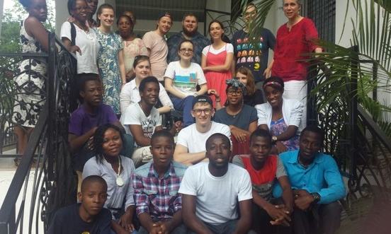 group of BRitish and Haitian young people sat on steps