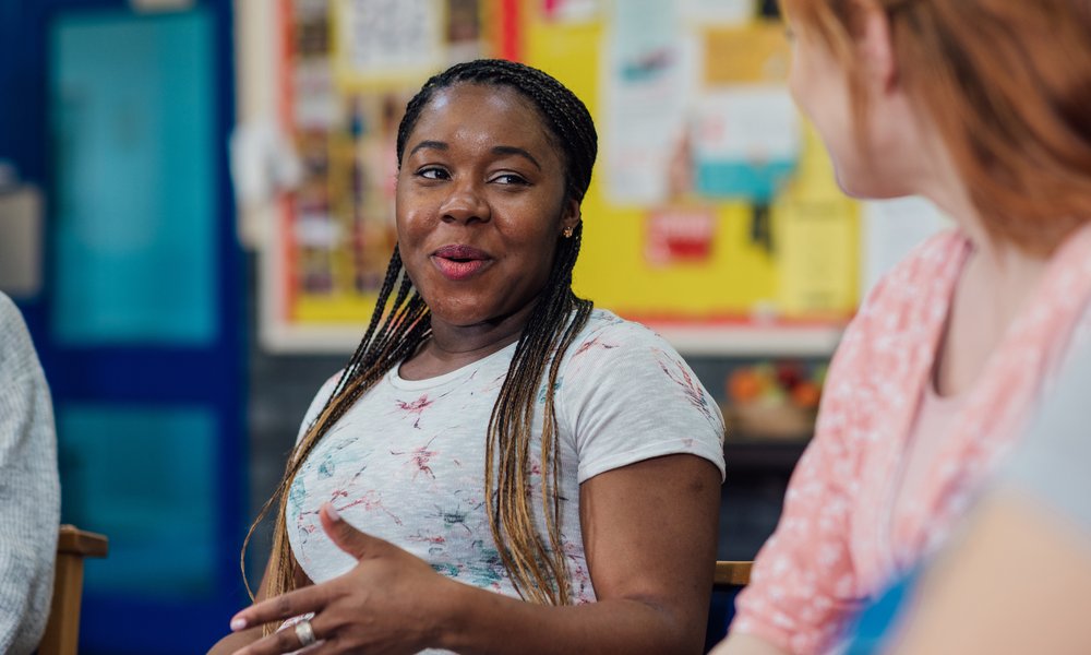 Young adults talking to mentor