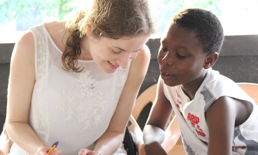 Girl teaching boy on Encounter Worldwide placement