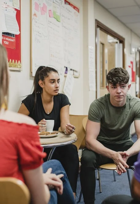 Small_group_o_teenagers_are_talking_to_a_ment