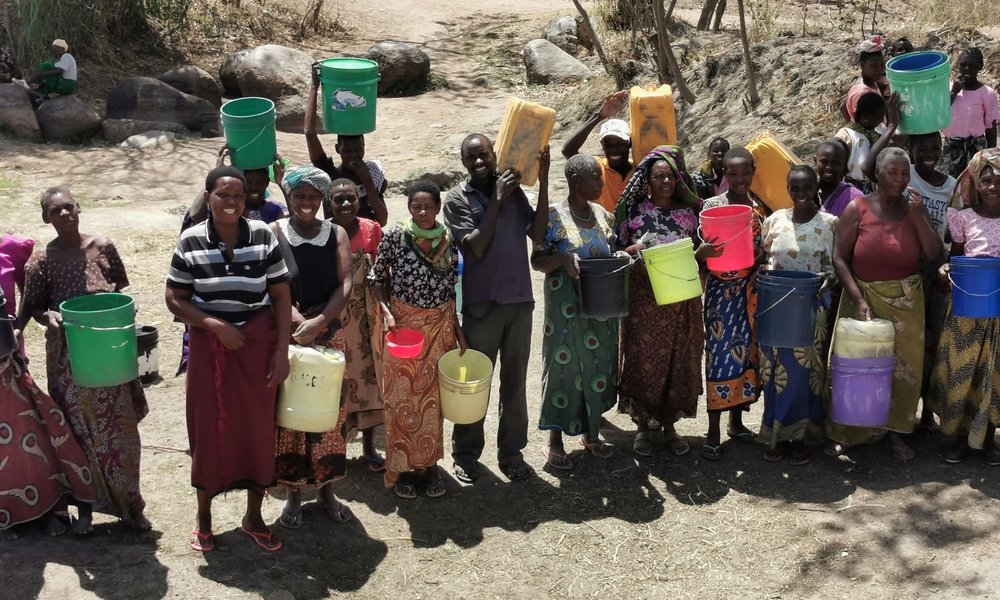 A crowd in Tanzania with water buckets