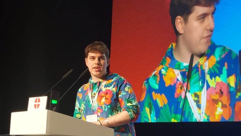 Tom Hart, Methodist Youth President standing at the lectern of the Methodist Conference