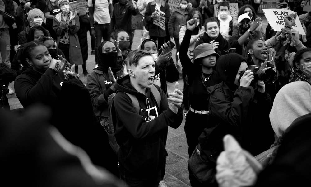 Black and white image on people on a protest.