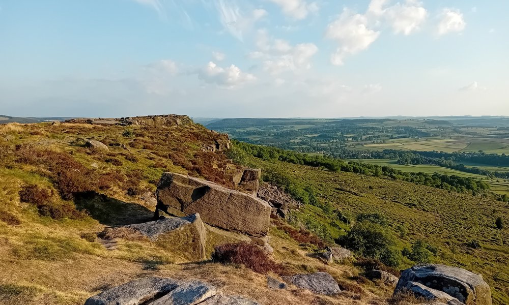 rugged edge and moorland overlooking green fields
