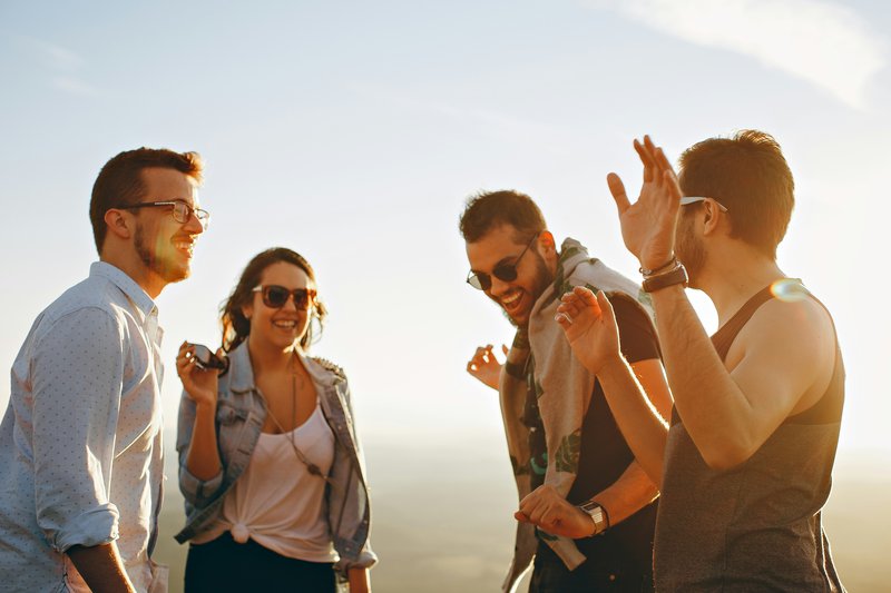 A group of people laughing in the sunshine