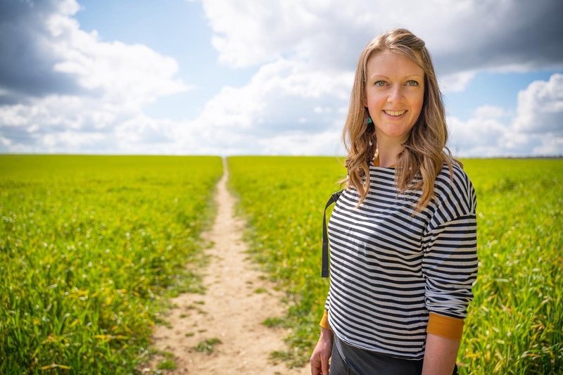 Holly Adams smiling in a field