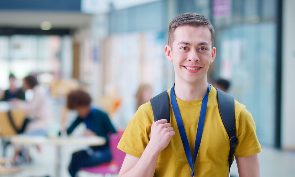 Male student smiles at camera
