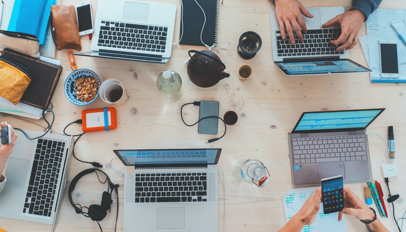 Birds eye view of table with computers