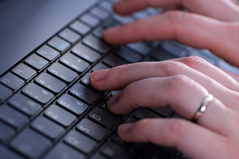 A person entering data using a keyboard