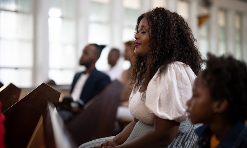 A congregation sits in prayer