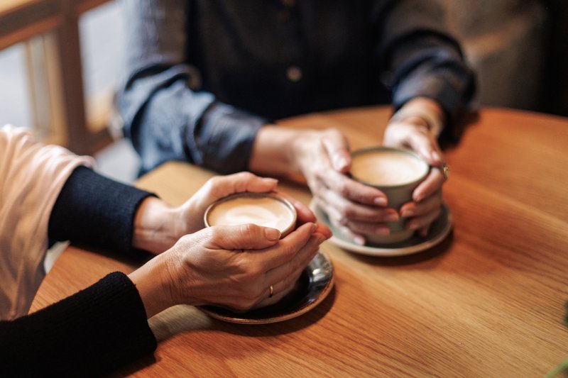 Two friends share a coffee