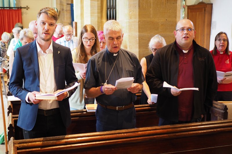 The congregation singing at the 'songs of praise' service